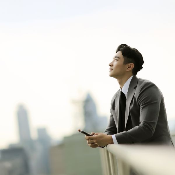 Businessman standing on city rooftop