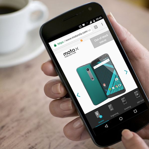 A hand holding a Motorola phone with Motorola Motomaker on the screen