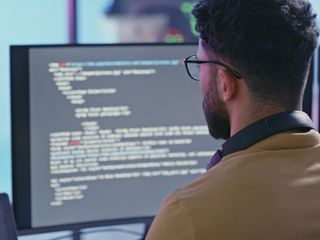 Computer coding, software development and programmer man writing code for cybersecurity analytics, seo data and digital cloud computing