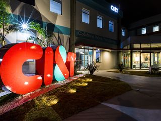 CI&T office entrance with big illuminated logo at night